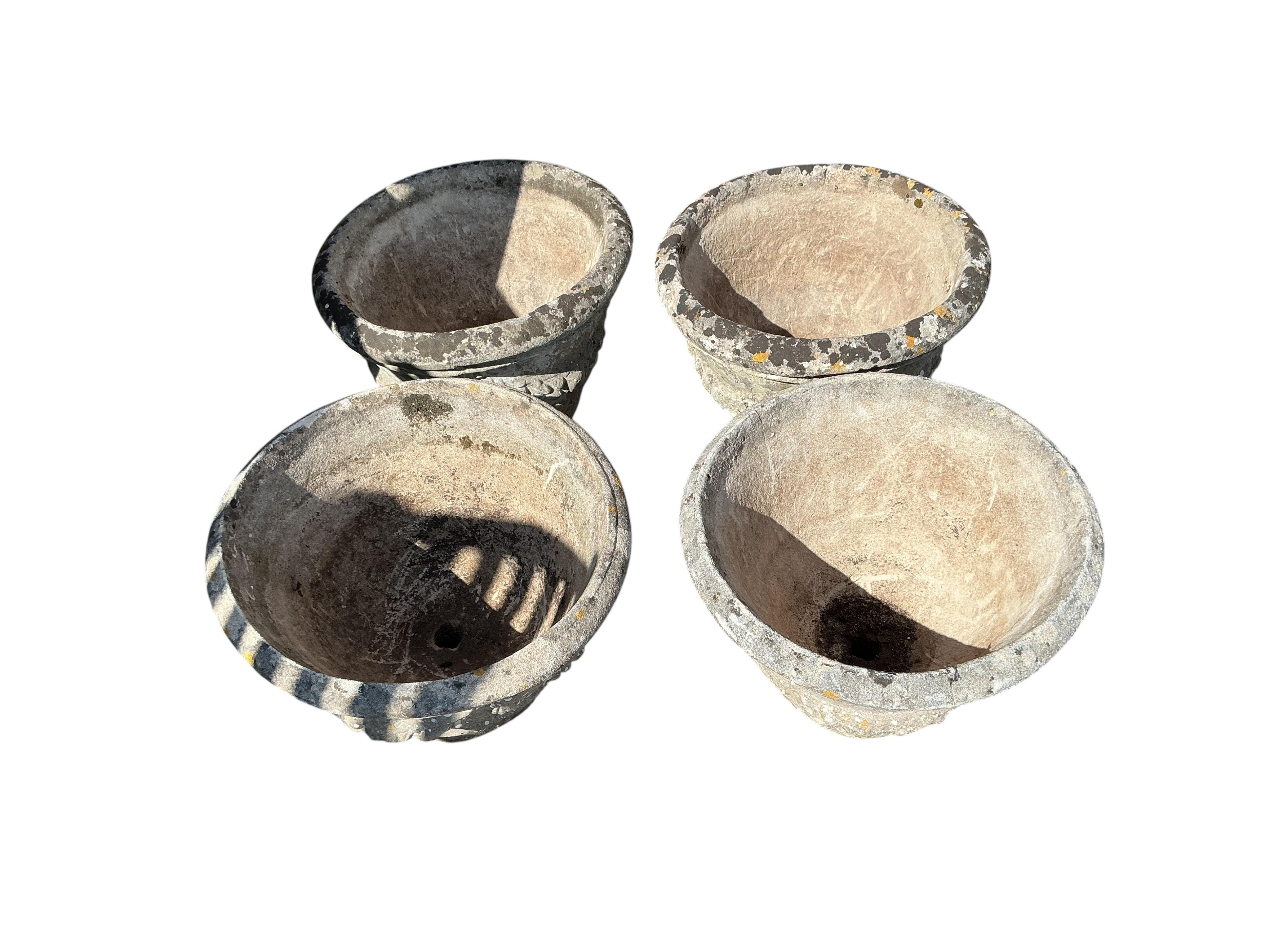 A set of four circular reconstituted stone garden planters, diameter 49cm, height 34cm